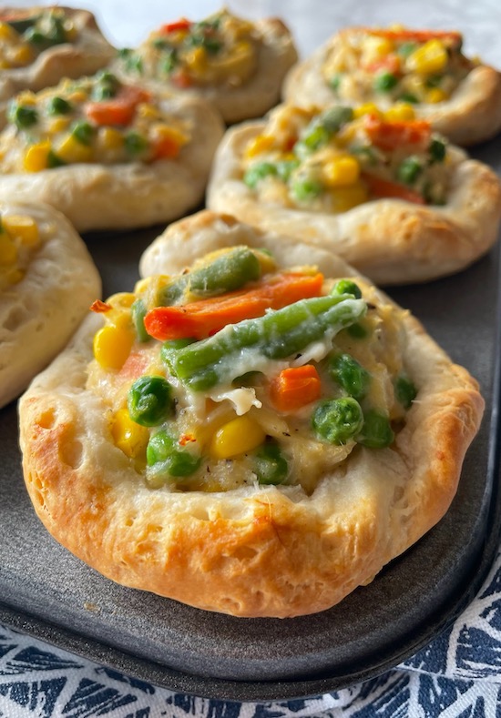 Mini chicken pot pies made in a muffin pan with Pillsbury biscuit dough.