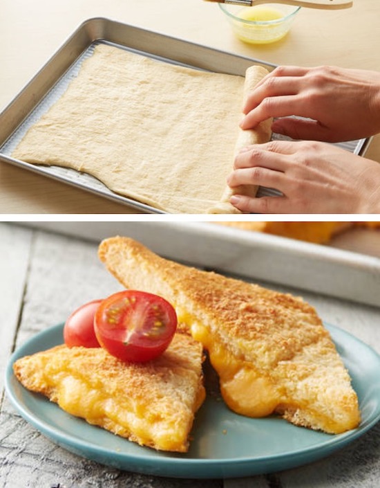 A sheet pan with crescent pizza dough spread out to make grilled cheese sandwiches for a crowd.