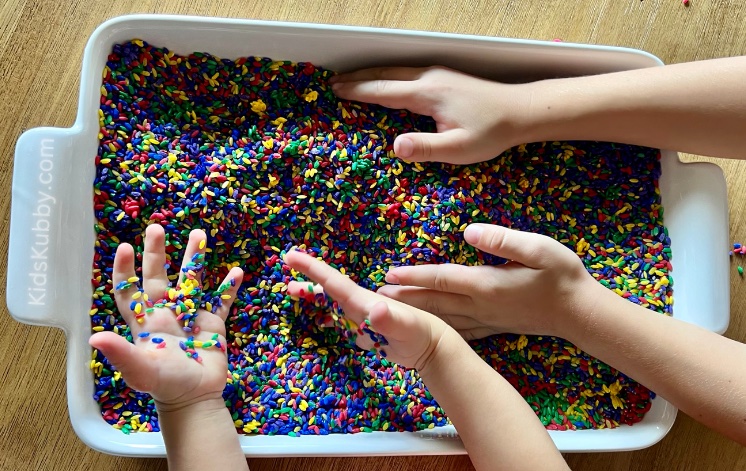 Busy toddlers playing with Rainbow rice