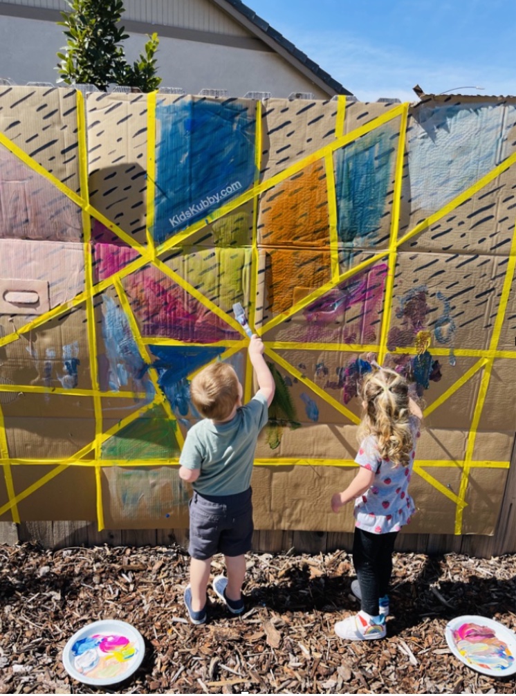 DIY Paint Mural for Toddlers | If you have kids at home that can't stay still for a minute, you've got to try these painter's tape ideas! They're perfect for playdates. Masking tape is super cheap and makes for a ton of fun and creative activities for both toddlers and preschoolers. 