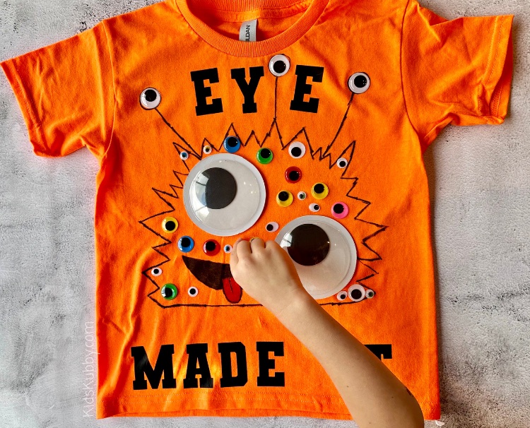 Are you looking for a fun idea for the 100th day of school project? Have your kids wear 100 items on a t-shirt. This easy and cheap 100 days of school DIY shirt idea is so cute, and your kids can help make it. Eye Survived 100 Days of School is the perfect theme for a googly eye monster t-shirt. Make sure to count out 100 googly eyes in all shapes, sizes, and colors, stick these on your homemade shirt and BAM you’ve got the best 100 days of school shirt ever! 