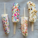 Do you need the perfect snack idea for your next bbq or kids birthday party? These frozen banana yogurt pops are the perfect treat your children and family will love. These delicious healthy no-bake treats are so easy to make.