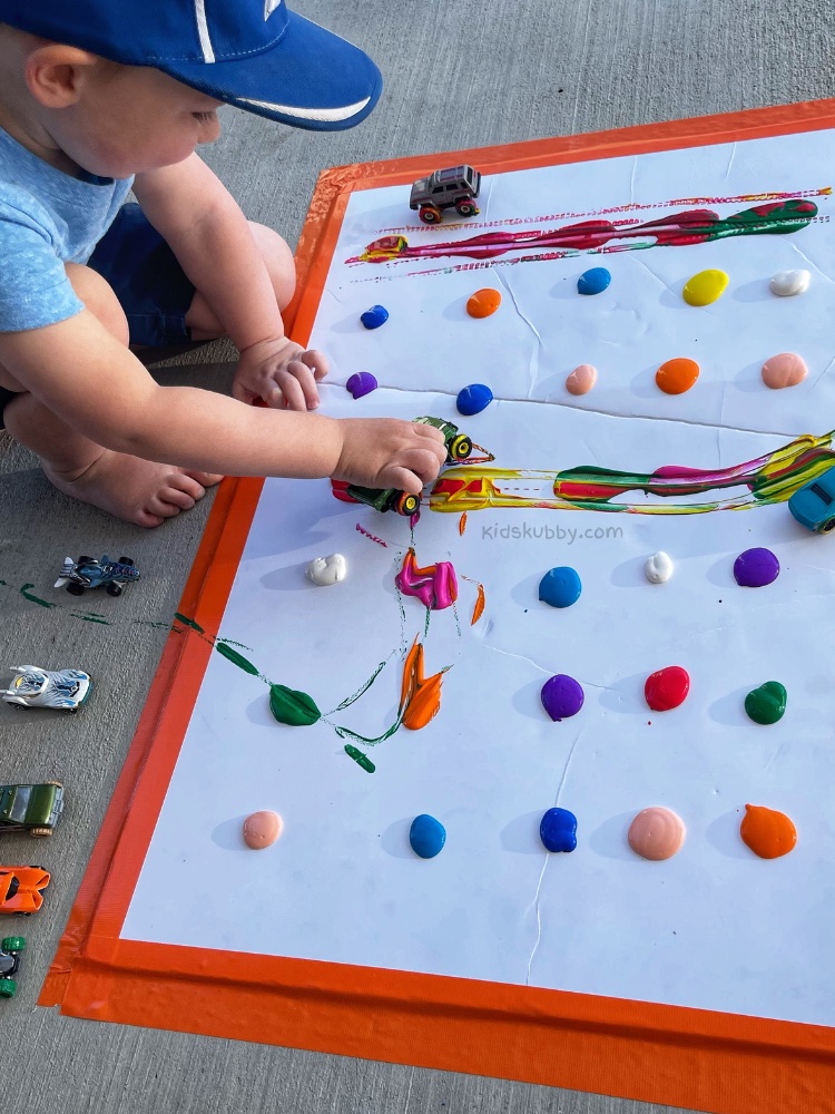 Painting with Cars | A super fun art project and outdoor activity! My kids had a blast making this DIY abstract wall art.