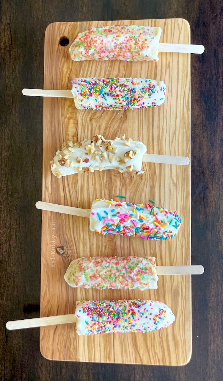 Banana popsicles! These fun and easy summer time treats are perfect for kids of all ages. My 3 year gobbles them up, and they are so much healthier than sugar-filled store bought popsicles or ice cream. They are made with just 3 ingredients including bananas, yogurt and optional sprinkle or nuts for added fun and color. No baking required!
