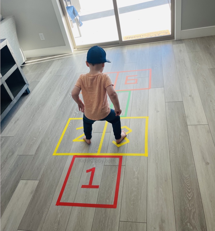 Indoor hopscotch using masking tape! A fun and easy way to keep toddlers and preschoolers active inside.