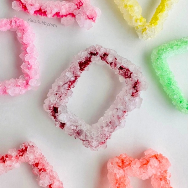 Are you looking for a fun science experiment to do at home with your kids? Try making Borax Crystal Shapes! These DIY crystals are made with pipe cleaners, water, and borax. That's it! Such an easy and fun activity for kids! Hang on your window or use as Christmas ornaments. These homemade crystals really are the perfect kids' craft!