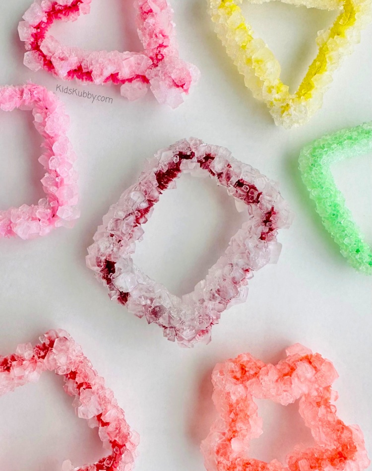 Are you looking for a fun science experiment to do at home with your kids? Try making Borax Crystal Shapes! These DIY crystals are made with pipe cleaners, water, and borax. That's it! Such an easy and fun activity for kids! Hang on your window or use as Christmas ornaments. These homemade crystals really are the perfect kids' craft!