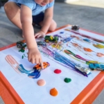 Your kids are going to love painting with cars. It is so easy with very little supplies you most likely already have at home-washable paint, toy cars, and paper. Let your child create their own little art piece by driving the cars through the paint.