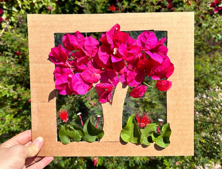 Are you looking for a fun and interactive nature craft for kids - Try making DIY Flower Trees out of cardboard boxes. With a few simple supplies including cardboard, clear tape, and flowers your kids can make pretty upcycled nature art that is sure to WOW. See how many different color and texture combinations your kids can find outdoors to make these pretty flower trees!