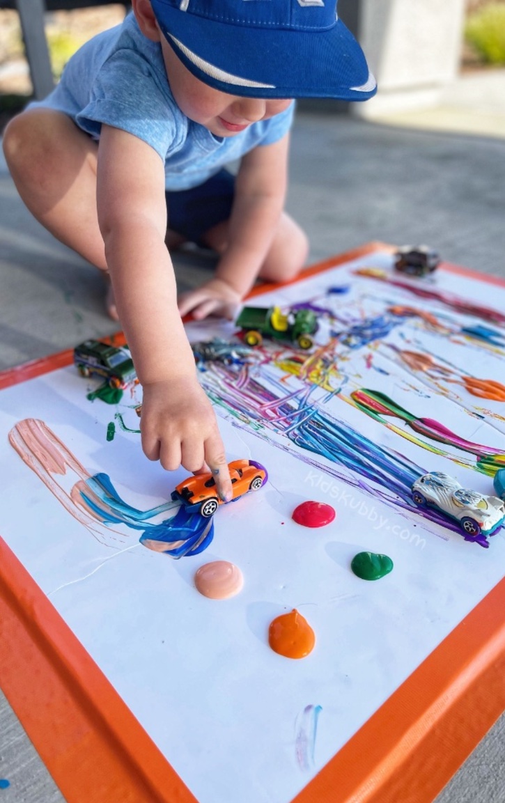 Your kids are going to love this fun and easy outdoor paint activity! It's so simple to do with supplies you probably already have at home. My boys have a ton of toy cars and trucks, and they had a blast with this outdoor art project.