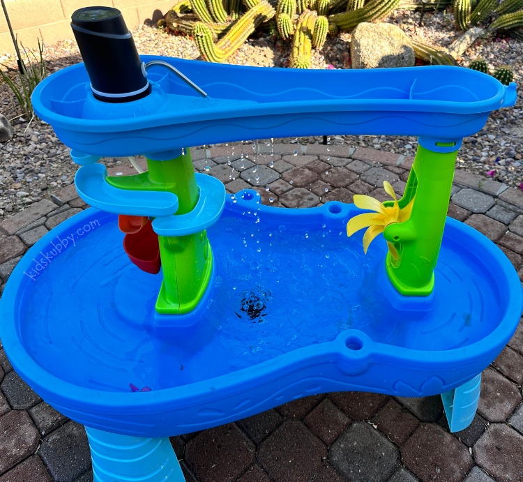 Ok here is the best summertime hack ever! With a cheap water pump from amazon, you can create a constant flowing fountain in your kid’s water table. Every kid loves a water table. Water is one of those things that can keep kids entertained for hours. Well with this simple water table hack, you can upgrade your water table to a fountain oasis in less than 5 minutes! I love this summertime trick because it creates so much joy for kids. Heck this mom hack can be used on any water toy your kids play with! 