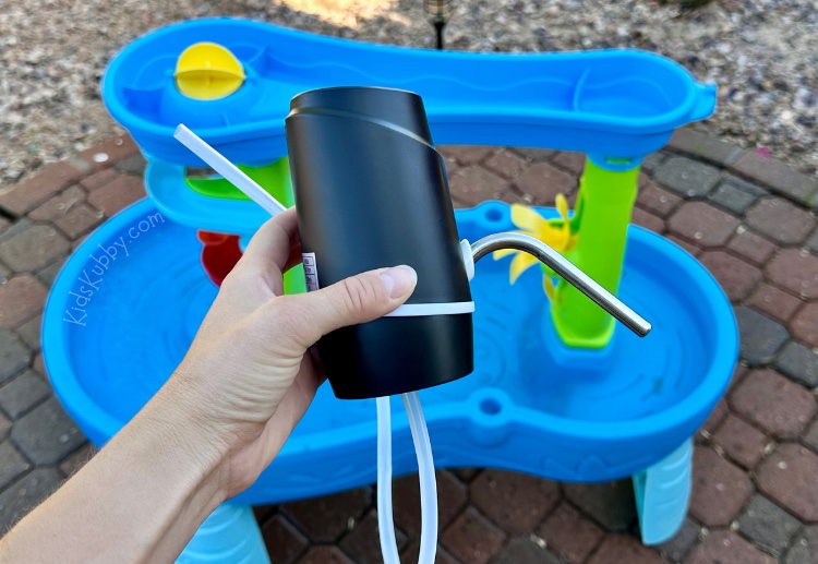 Simple and cheap summertime hack for busy parents. With one inexpensive water pump and a water table you can create a fun outdoor activity for summer that will keep your kids entertained for hours. Plus, you can use this amazing parent hack on any water toy your kids have. Create the best summer memories with this easy and budget friendly outdoor water table hack.