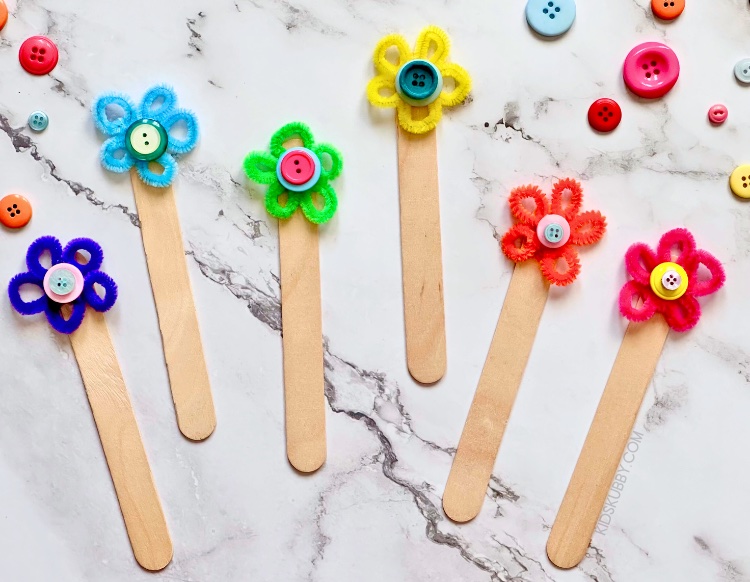 I’m always looking for easy craft ideas for kids and these homemade flower bookmarks are perfect. Each bookmark only takes 5 minutes and uses just a few cheap supplies like popsicle sticks, pipe cleaners, and buttons. I can’t tell you how excited my kids were to read just so that they could use their new pipe cleaner flower bookmarks. This simple craft would also be great for sleepovers and party favors too!
