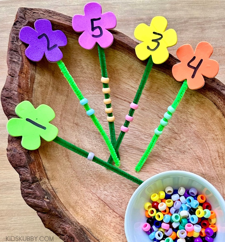 How cute is this foam flower counting activity? It’s great for toddlers and preschoolers as they learn to count. Head to the dollar store today to pick up some foam flowers, green pipe cleaners, and pony beads. This counting game takes 5 minutes to prepare and will keep kids entertained for much longer! 