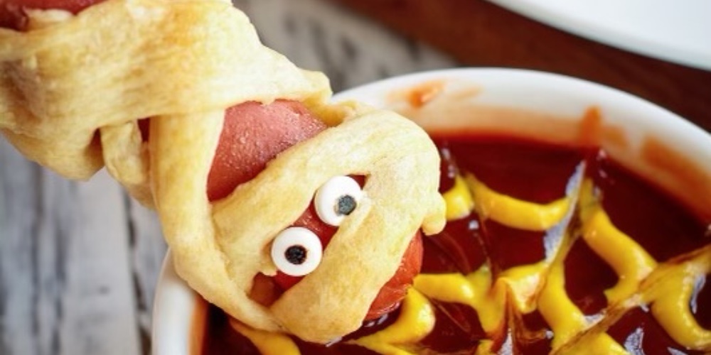 Check out this easy family dinner idea this Halloween season. With just 3 ingredients including your favorite hot dogs, pillsbury crescent roll dough, and candy eyes, you can make the perfect Halloween recipe that everyone will love. Add a bowl of ketchup and mustard spider webs and you've got an easy dinner in less than 20 minutes.