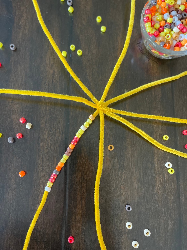 Looking for inexpensive and super easy craft to do with the kids this fall? Gather pipe cleaners and pony beads and get your craft one making these adorable colorful beaded corn to help decorate your home or class room this fall!