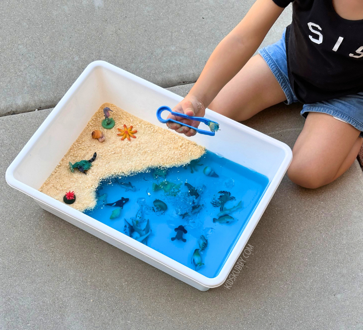 Do your kids love the ocean and all the sea creatures in it? This under the sea jello sensory bin is perfect for your little ocean loving toddlers. head outside and let your kids explore the squishy jello with their hands, feet, and even their mouth because this sensory bin is edible! perfect for babies and toddlers who put everything in their mouths. You can find all the supplies at the dollar store too!