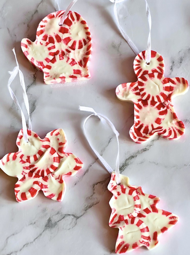 Check out this extra fun craft for Christmas! I loved making these easy homemade ornaments using peppermint candies. Simply melt peppermint pieces in Christmas shaped cookie cutters. Tie a pretty ribbon on top and these DIY ornaments make the cutest gifts this holiday season. 