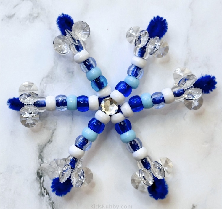 how adorable are these beaded pipe cleaner snowflakes. My kids love this fun Christmas activity, perfect for the holidays.  add a pretty ribbon and turn these into DIY ornaments for your christmas tree!