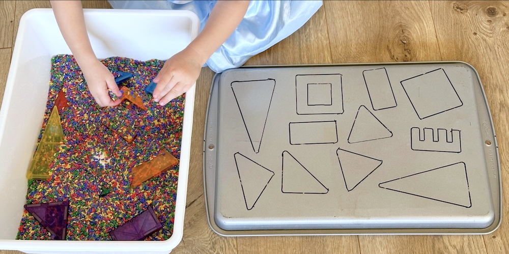 a fun and budget friendly activity for kids. This sensory play idea helps kids learn their shapes while they play. What could be better. Learning through play is the best.