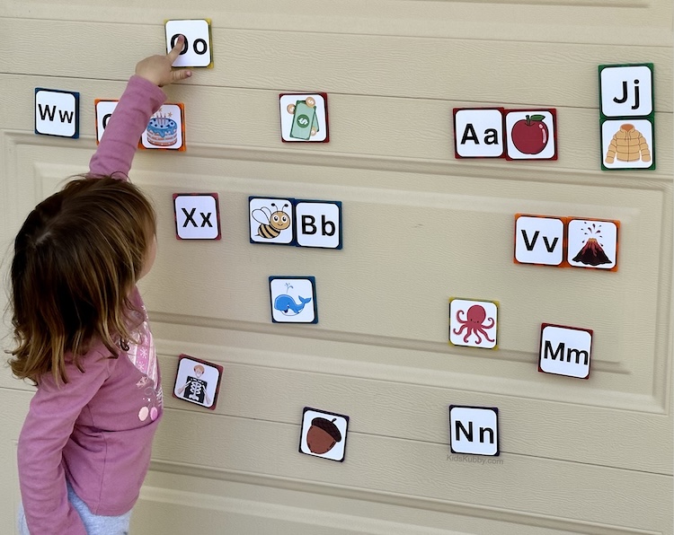 Looking for a fun activity for kids? Try making this easy phonics game with a free printout and magnetic tiles. Head outside and let your kids play with magnetic on the garage door while they learn an essential pre-reading skill. Such a fun game for kids.