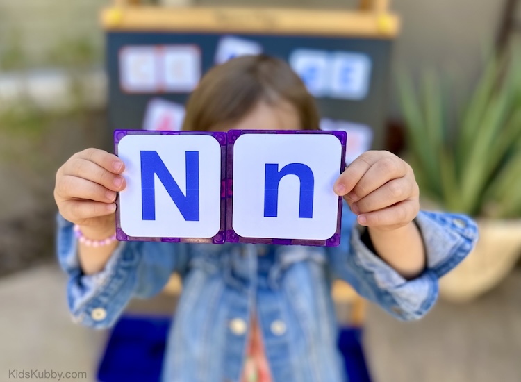 If you're looking for a fun way for kids to learn the alphabet this ABC match game is perfect! all you need is some magna-tiles, this free printable, and some tape. Find a magnetic surface in your house like the refrigerator or garage door and your kids can match letters all day!