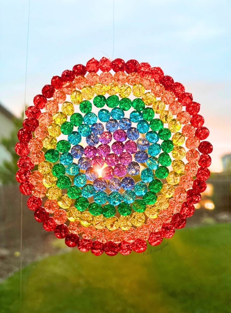 DIY colorful suncatchers craft project to make with your kids! My preschoolers and older kids both had a lot of fun making these one day when bored at home. They look awesome hanging in the window of our playroom. 