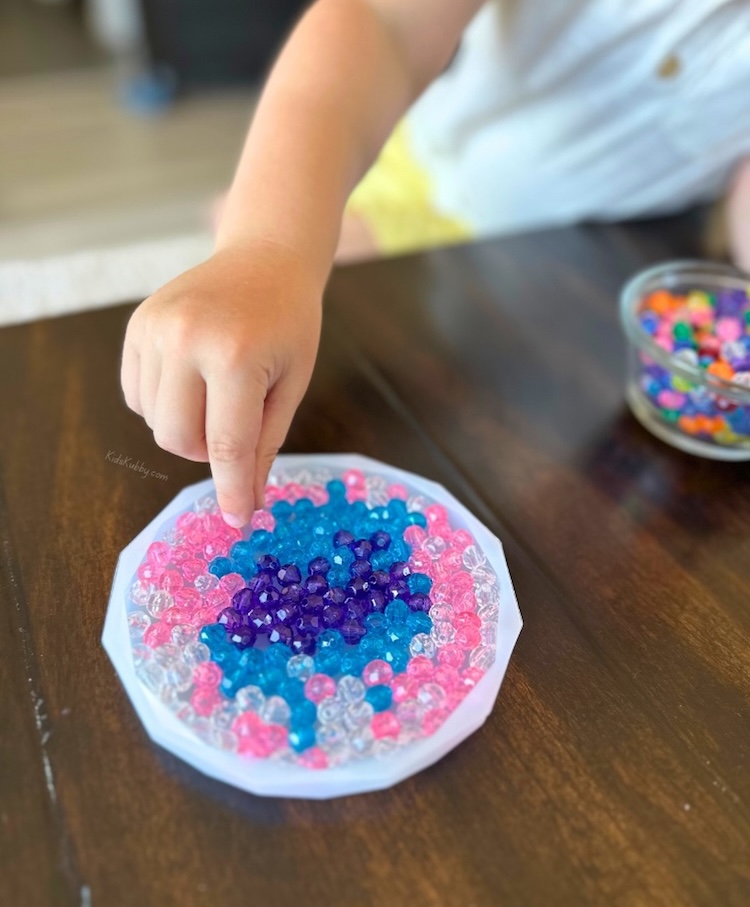 How to make beautiful melted bead suncatchers at home with your kids using beads and silicone molds in your toaster oven. 