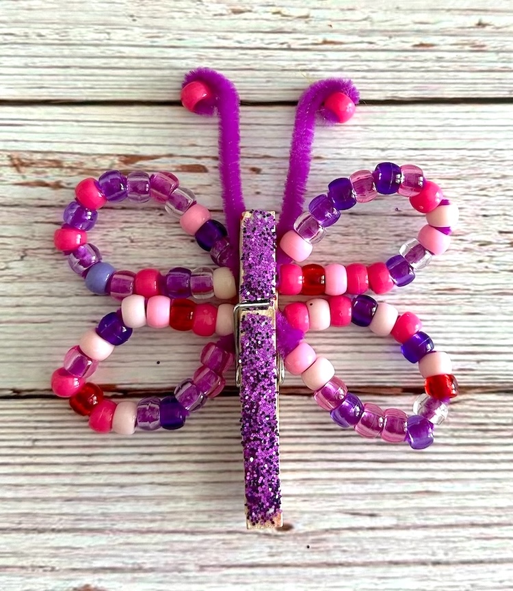 Easy craft idea for kids to make! DIY Butterflies made with clothespins, beads, and pipe cleaners. 