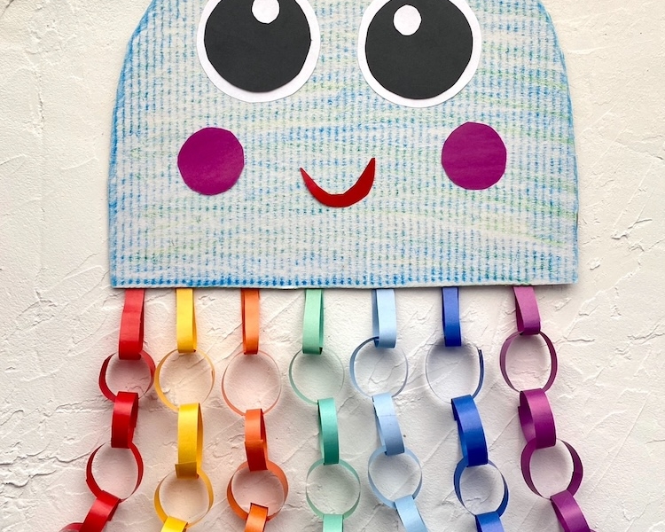 Easy colorful jellyfish craft idea for kids made with constructions paper and recycled cardboard. A fun project to do at home when bored! This ocean themed craft is fun for children of all ages.