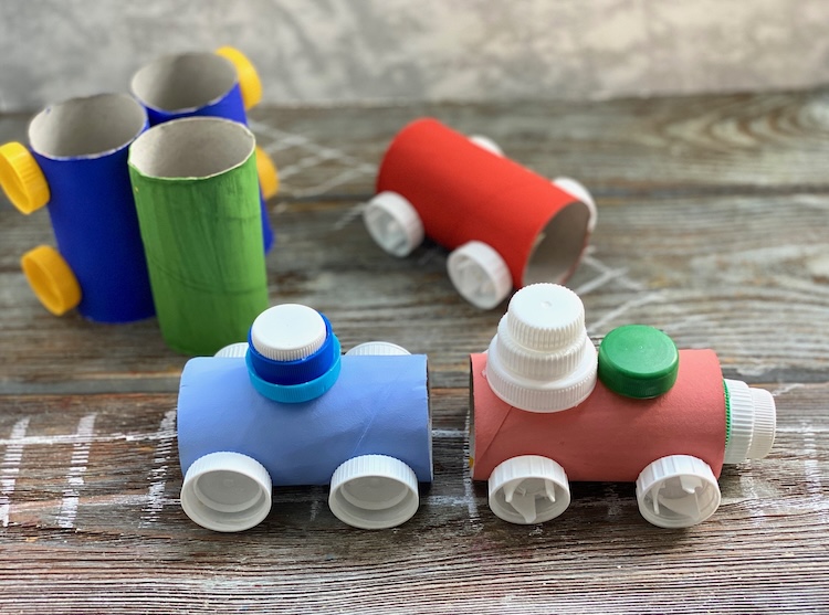 Fun toilet paper roll craft for kids made with cheap recycled materials from home including plastic bottle caps! Step by step tutorial on how to make a cardboard train set.