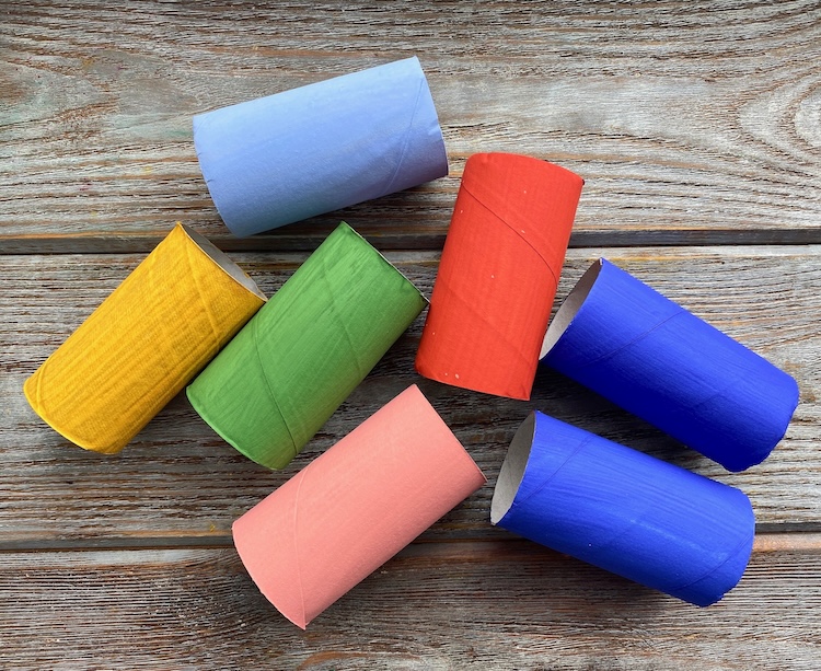 Craft made with recycled toilet paper rolls, colorful paint, and plastic bottle caps!