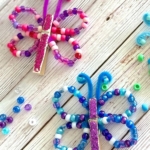 DIY Craft Tutorial For Kids | How to make charming little butterflies out of just a few common craft supplies! Pony beads, pipe cleaners, and clothespins.