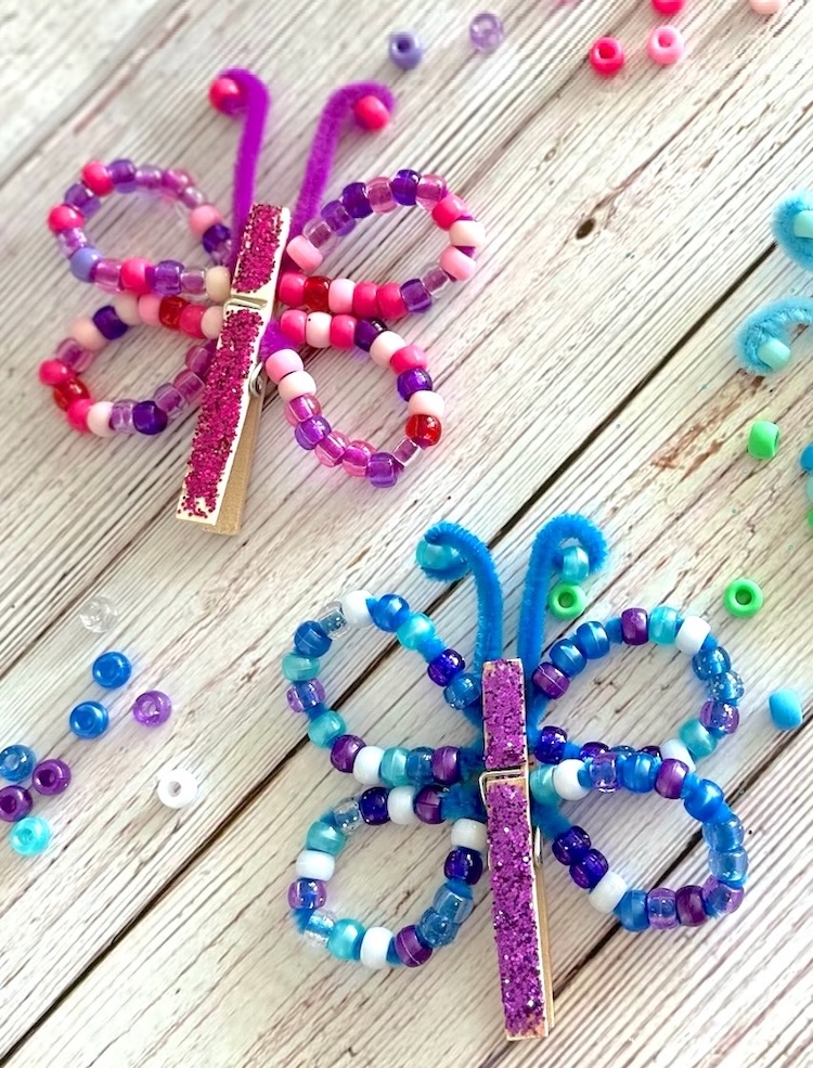 DIY Craft Tutorial For Kids | How to make charming little butterflies out of just a few common craft supplies! Pony beads, pipe cleaners, and clothespins. 