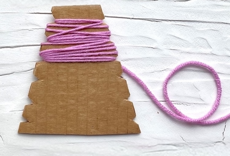 Easy yarn craft for beginners using cardboard to make a bunny project.