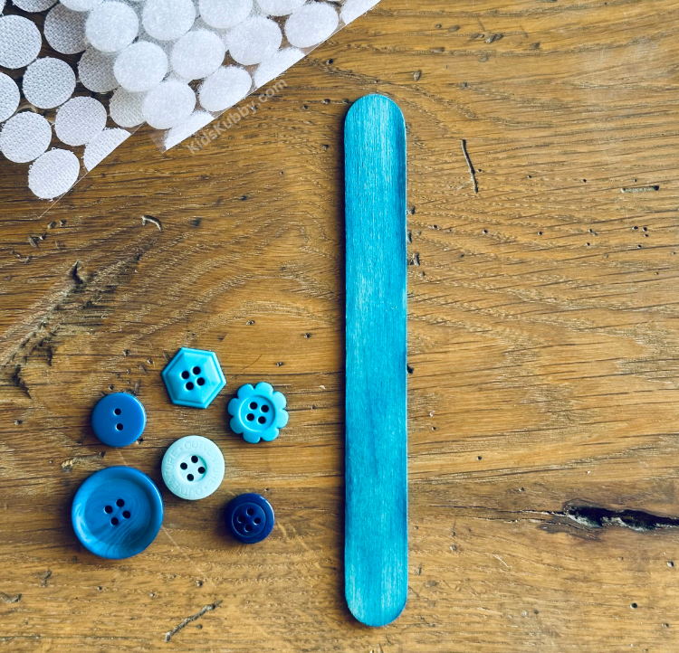 How to create a color sorting game from popsicle sticks, buttons, and velcro dots. 