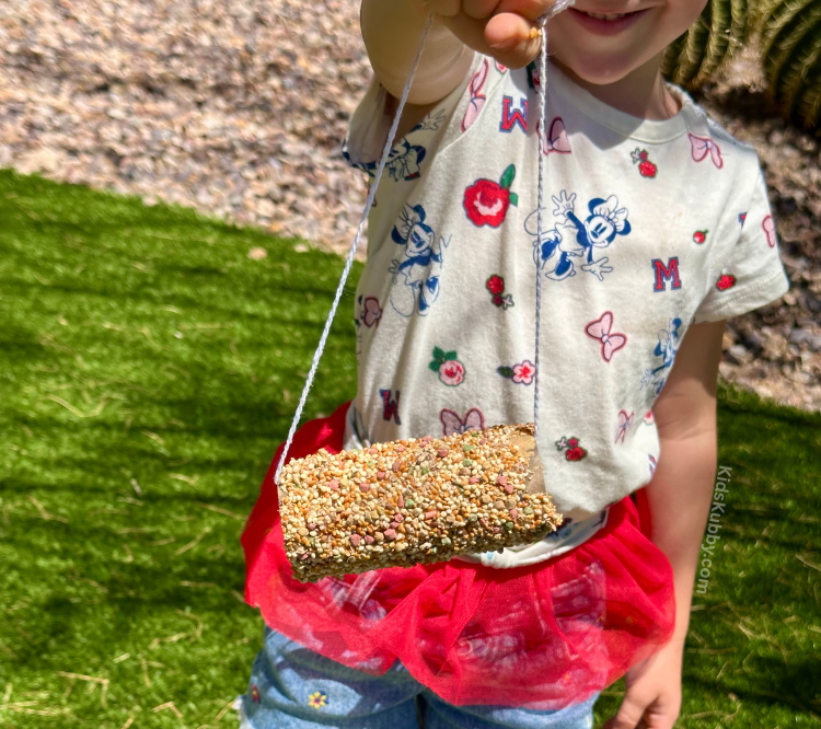A simple and fun outdoor activity for kids making homemade bird feeders with recycled toilet paper rolls.