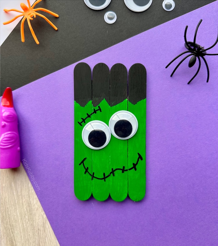 Simple and fun Halloween craft idea for preschoolers using cheap supplies you probably already have at home. Grab some jumbo popsicle sticks, paint, and googly eyes to make the cutest Frankenstein craft ever! Perfect for toddlers and preschoolers.