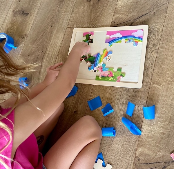 How to make a fun hunt and seek game for kids using puzzle pieces and tape.