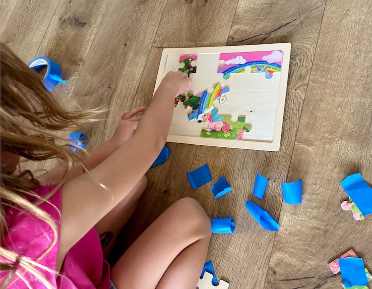 How to make a fun hunt and seek game for kids using puzzle pieces and tape.
