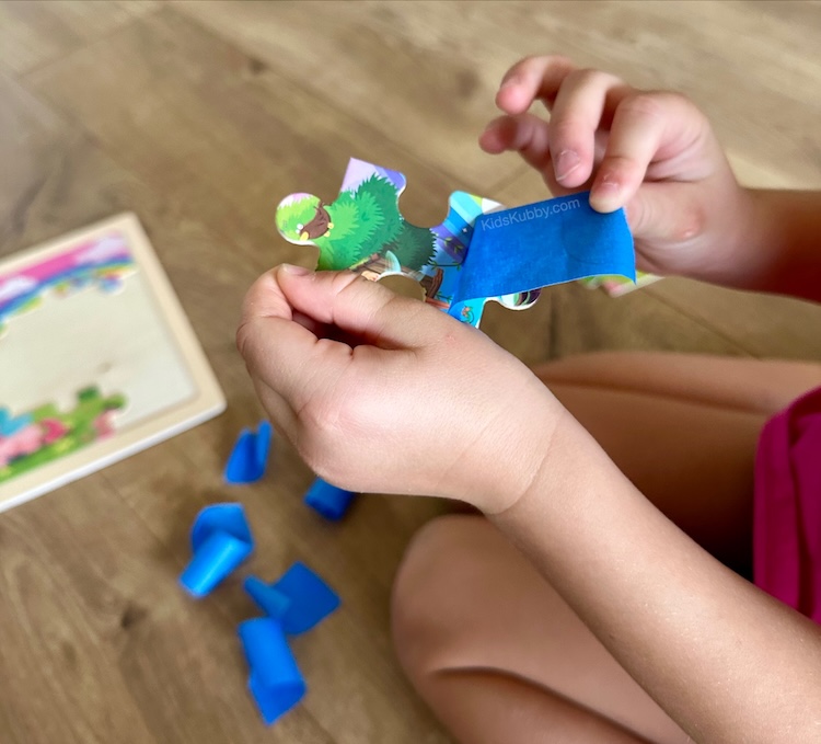 Easy fine motor activity for kids using tape and puzzle pieces.