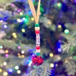A budget friendly Christmas activity for kids using pony beads to make homemade ornaments with names.