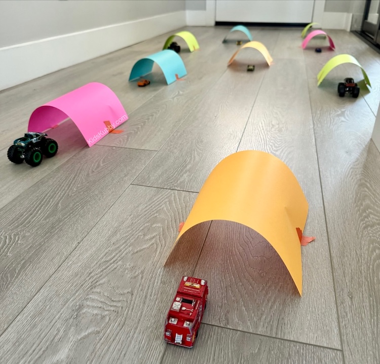 I love how easy and cheap this fun activity is. Tape some paper to the floor to create an obstacle course for toy cars. Great rainy day fun for kids. 
