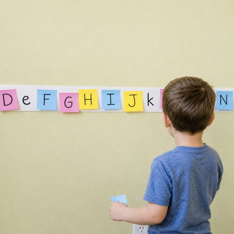 Alphabet learning game using post it notes and paper. An easy learning activity for 3 and 4 year olds. 