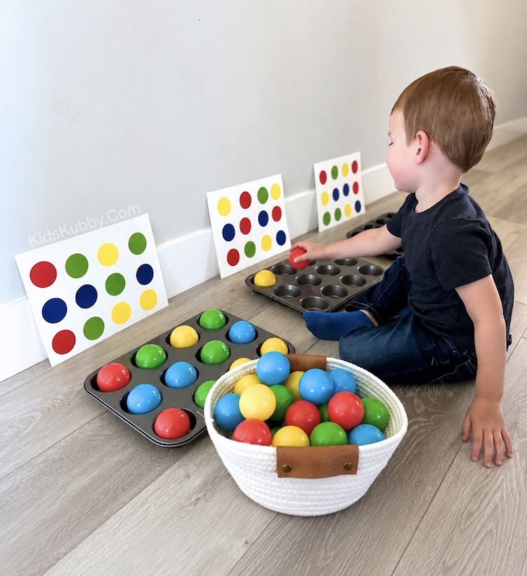 Color recognition and patter game for preschoolers using colorful plastic balls and a large muffin tin. 