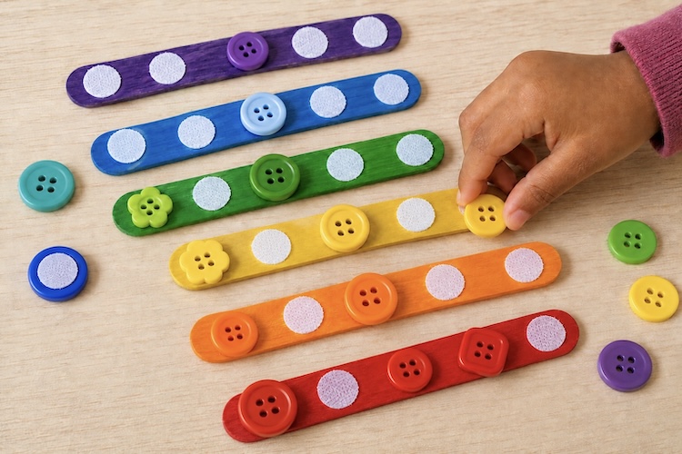 Easy button activity for kids using colorful popsicle sticks and velcro dots to create a fun learning activity. 