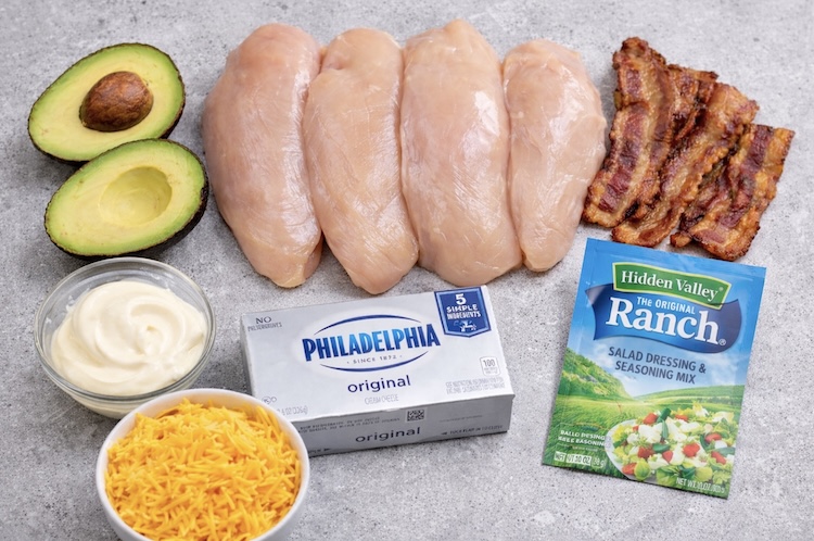 Chicken breasts with cream cheese, mayo, ranch seasoning, cheddar, and bacon to make a delicious kid friendly baked chicken dish.
