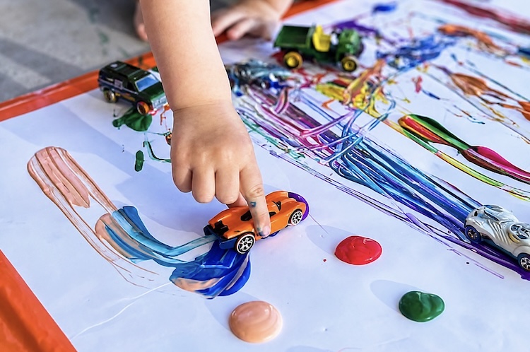 Let your toddlers and preschoolers have a blast outside while creating art with their toy cars.