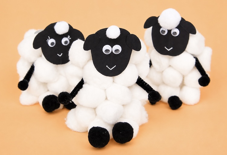 paper roll tube sheep craft made with fuzzy cotton balls and pipe cleaners.