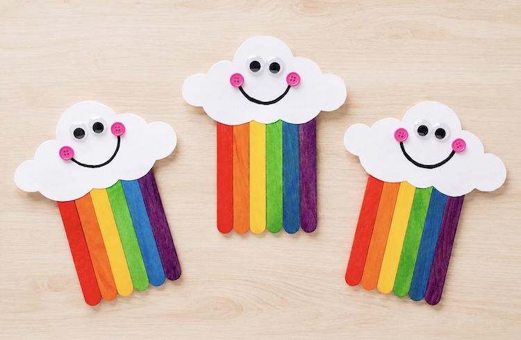 Craft stick project for kids. How to make an adorable spring rainbow on your next rainy day at home.